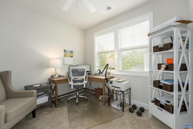 office featuring baseboards, a ceiling fan, and visible vents