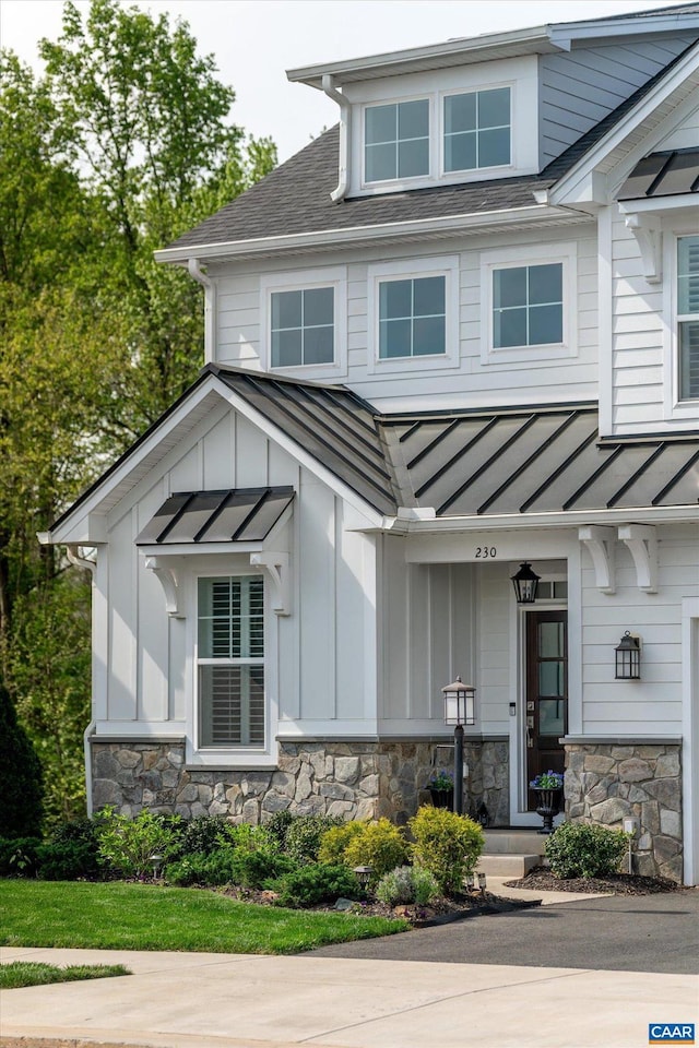 view of front of home featuring a standing seam roof, board and batten siding, and metal roof