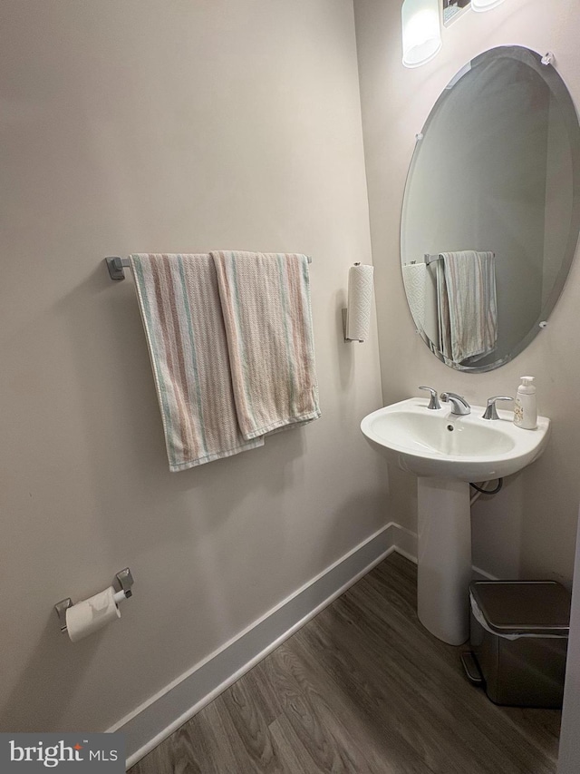 bathroom with wood finished floors and baseboards