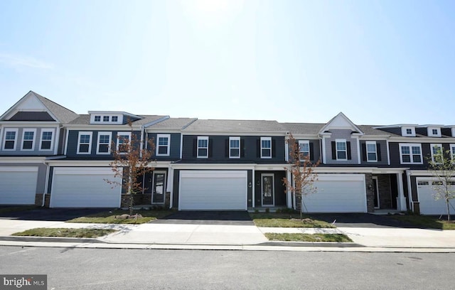 townhome / multi-family property featuring a garage and driveway