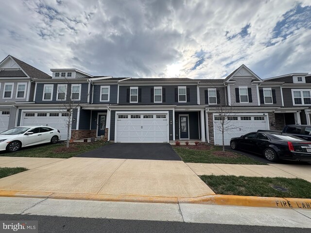 multi unit property with driveway and an attached garage