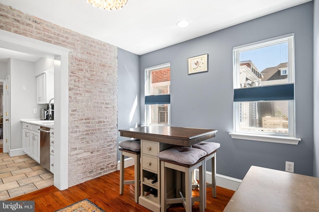 dining area featuring light wood-type flooring and baseboards