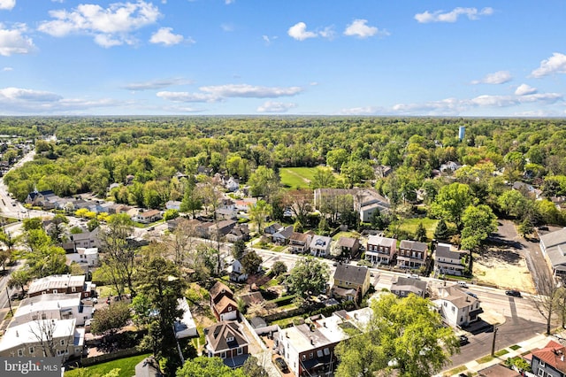 birds eye view of property with a residential view and a wooded view