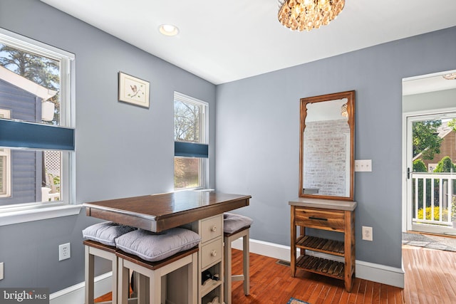 dining area featuring a healthy amount of sunlight, baseboards, and wood finished floors