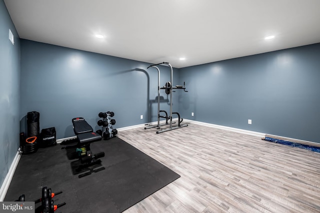 workout area with wood finished floors, recessed lighting, and baseboards