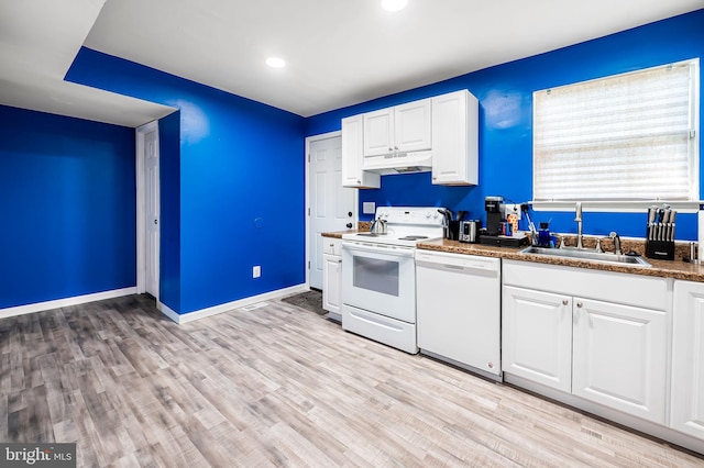 kitchen featuring a sink, white cabinets, under cabinet range hood, and white appliances