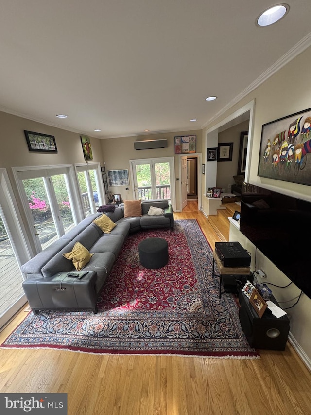 living area featuring ornamental molding, wood finished floors, recessed lighting, and a wall mounted AC