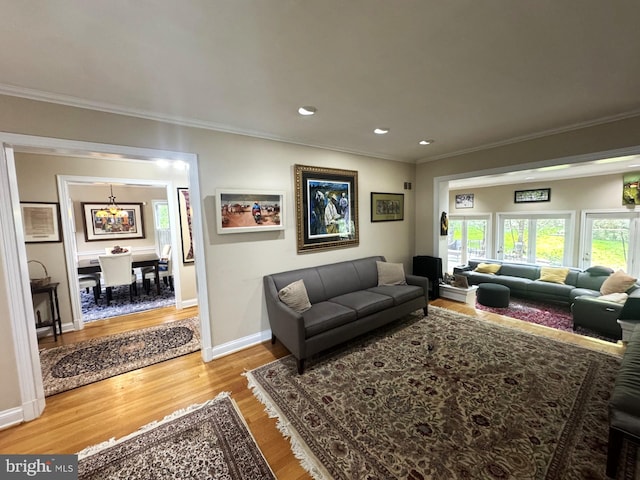 living room featuring crown molding, recessed lighting, a wealth of natural light, and wood finished floors