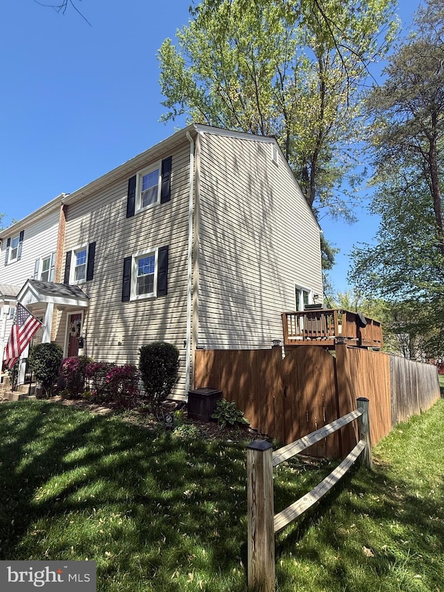 view of side of property with a lawn
