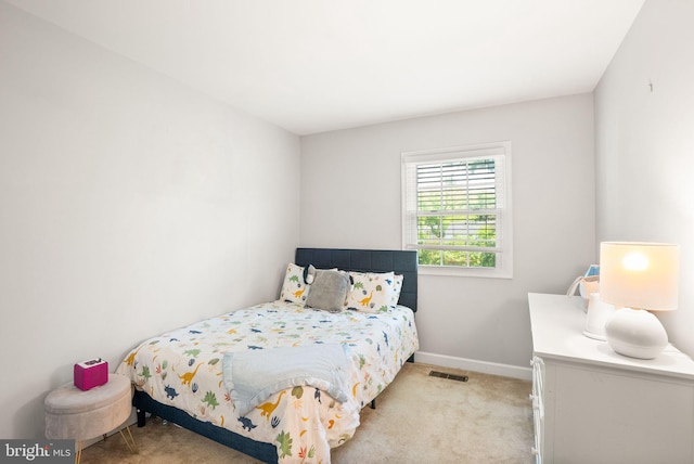 carpeted bedroom featuring baseboards and visible vents