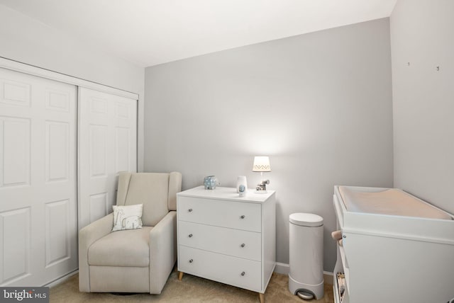 interior space featuring baseboards and light carpet