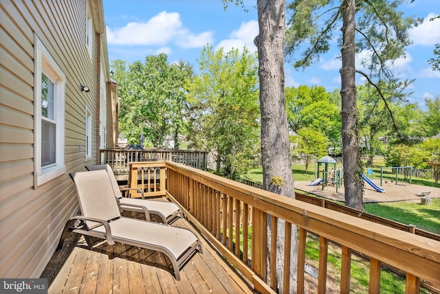 wooden terrace with a playground