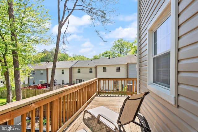 wooden deck with fence and a residential view