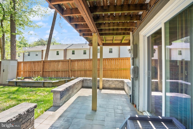 view of patio featuring a fenced backyard, a shed, and an outbuilding
