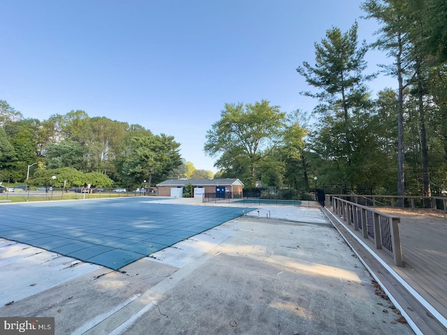 community pool featuring a patio area and fence