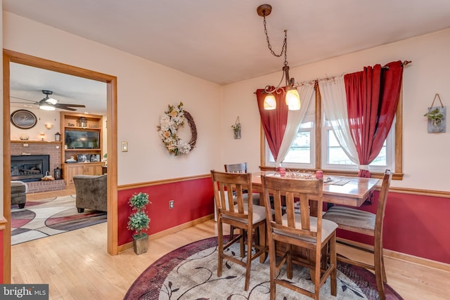 1085 Greenwood Rd, Winchester, VA 22602 - dining room with wood finished floors, a fireplace, and baseboards