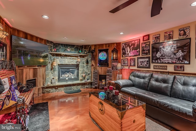 1085 Greenwood Rd, Winchester, VA 22602 - living room with a stone fireplace, ceiling fan, recessed lighting, concrete floors, and wooden walls