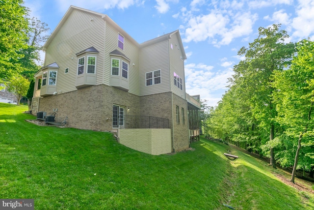 6725 Accipiter Dr, New Market, MD 21774 - rear view of property with a yard and brick siding