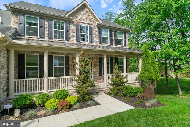 6725 Accipiter Dr, New Market, MD 21774 - view of front facade with a porch, a standing seam roof, stone siding, and a front yard