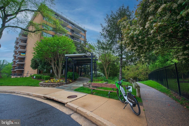 surrounding community with a pergola, a yard, and fence