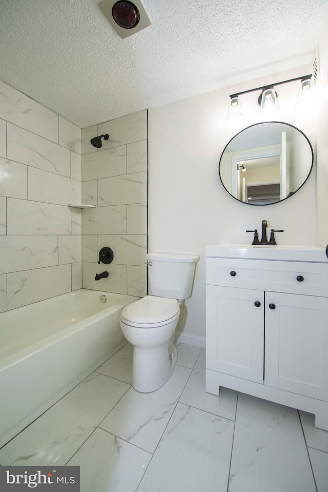 bathroom with a textured ceiling, vanity, toilet, and marble finish floor