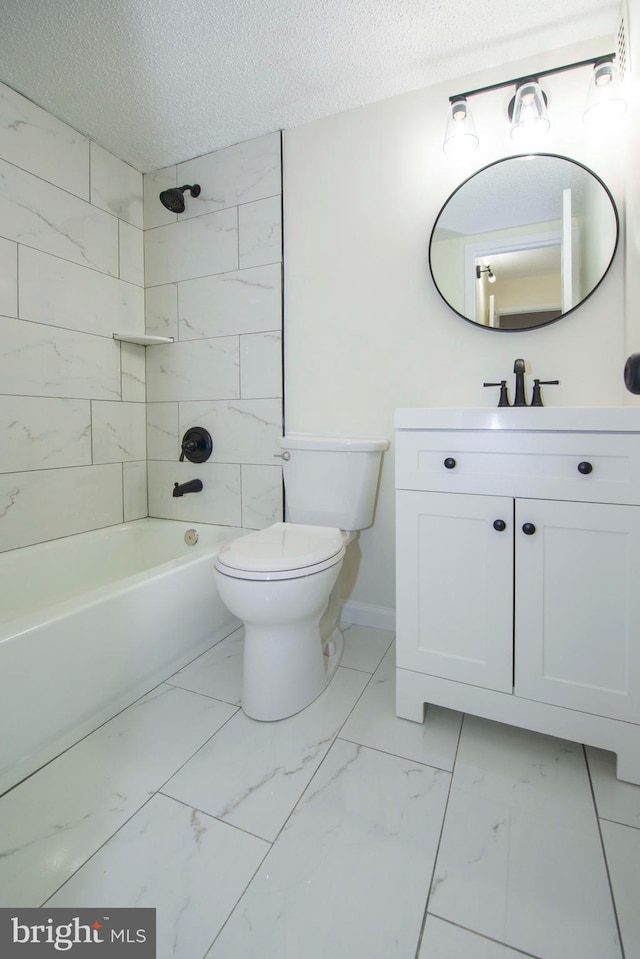 bathroom featuring a textured ceiling, vanity, toilet, and marble finish floor