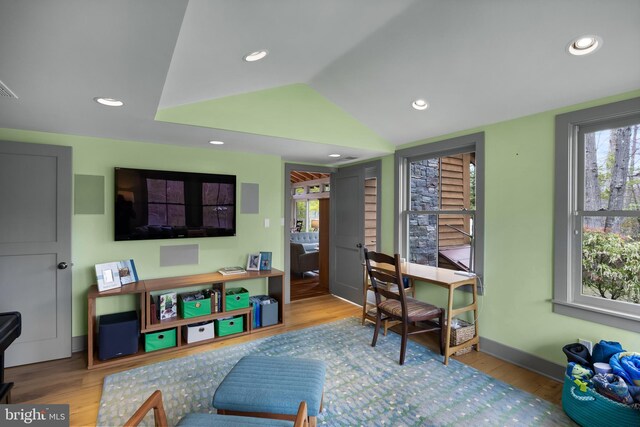 home office featuring recessed lighting, baseboards, wood finished floors, and vaulted ceiling
