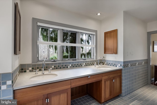 full bathroom with tile patterned floors, a wealth of natural light, and a sink