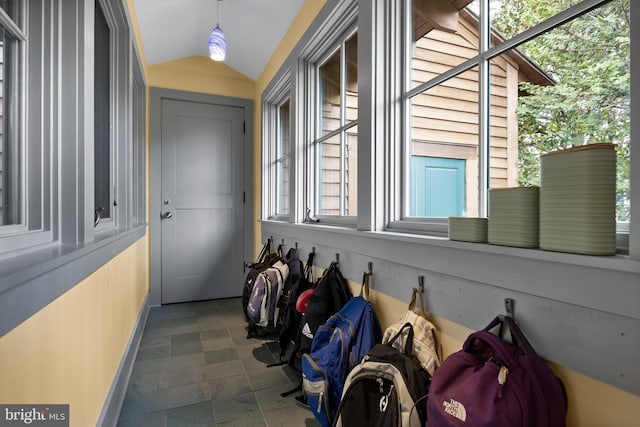 interior space featuring baseboards and vaulted ceiling