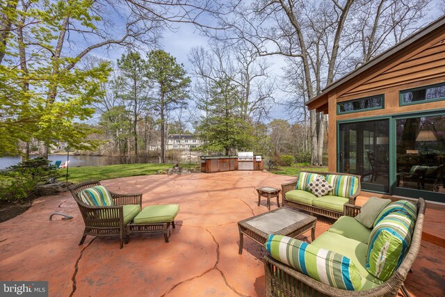 view of patio featuring a water view, an outdoor living space, and area for grilling