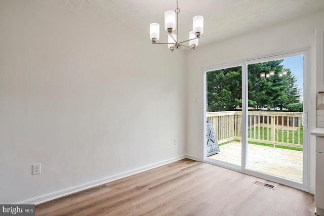 1603 Norwich Dr, Frederick, MD 21701 - unfurnished dining area featuring a chandelier, wood finished floors, baseboards, and a textured ceiling