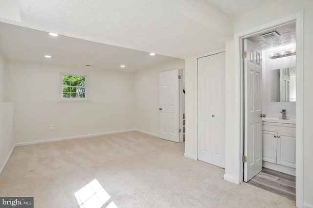 1603 Norwich Dr, Frederick, MD 21701 - basement with light carpet, baseboards, a textured ceiling, and recessed lighting