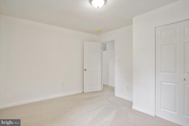 1603 Norwich Dr, Frederick, MD 21701 - unfurnished bedroom featuring light colored carpet, a textured ceiling, and baseboards