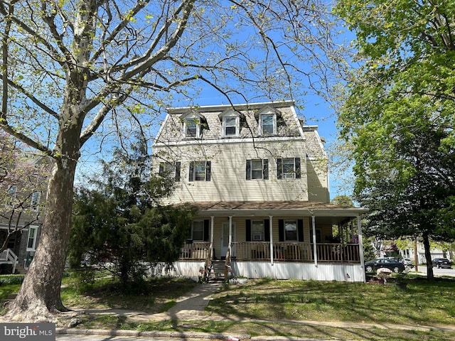 victorian home featuring a porch and a front yard