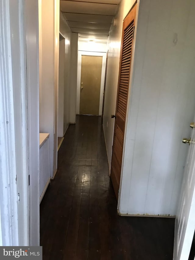 corridor with dark wood-style floors
