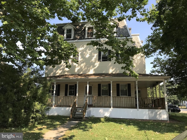 view of front of property with a porch and a front yard