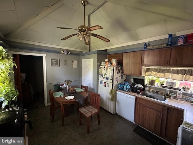 kitchen featuring dark carpet, a sink, ceiling fan, light countertops, and white appliances
