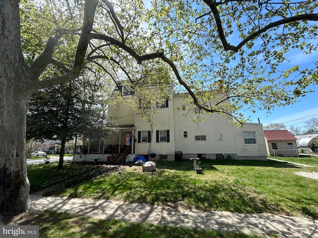 exterior space featuring a chimney and a yard