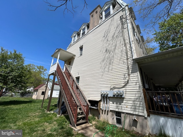 exterior space featuring stairway and a yard