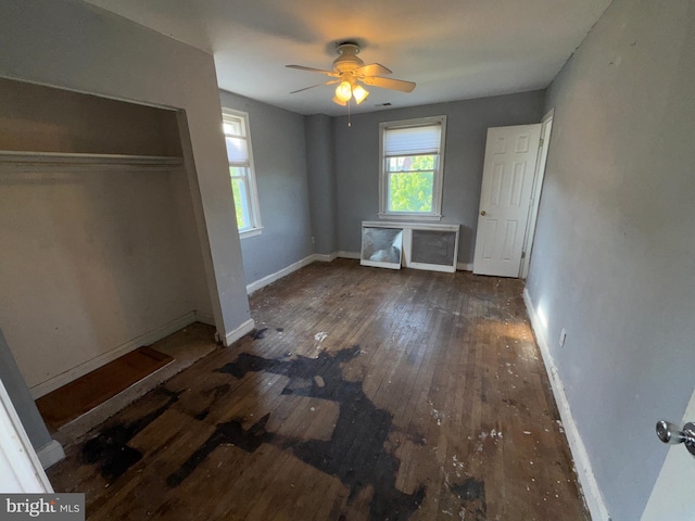 unfurnished bedroom with baseboards, a ceiling fan, and hardwood / wood-style floors