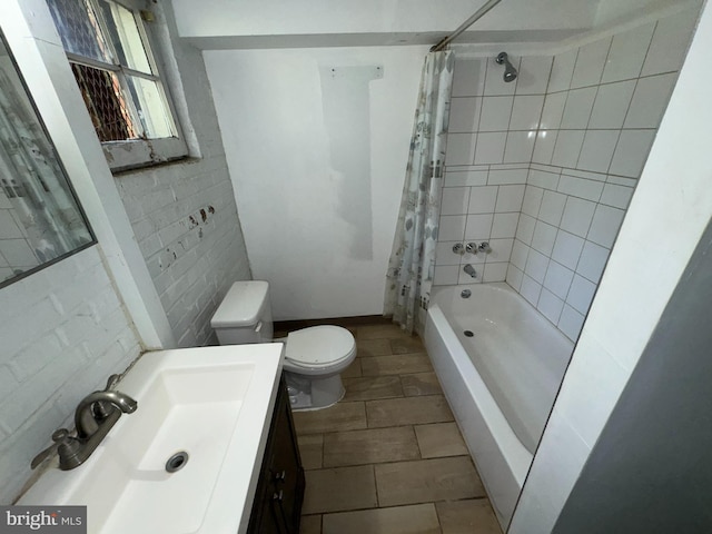 full bathroom with shower / bath combo with shower curtain, toilet, and vanity