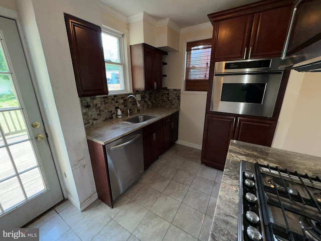 kitchen with a sink, backsplash, light tile patterned floors, a wealth of natural light, and stainless steel appliances