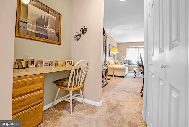 office space featuring light colored carpet and baseboards