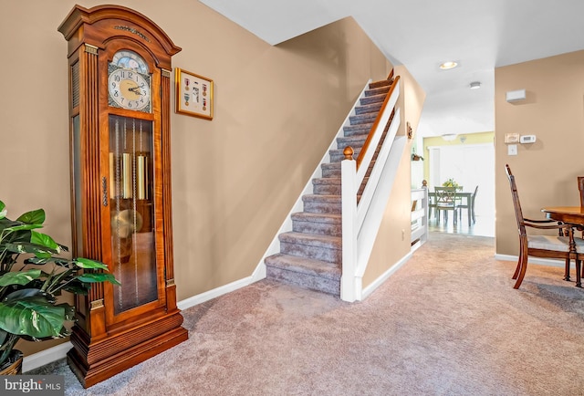 stairs featuring carpet and baseboards