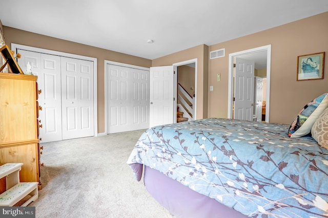 carpeted bedroom with two closets