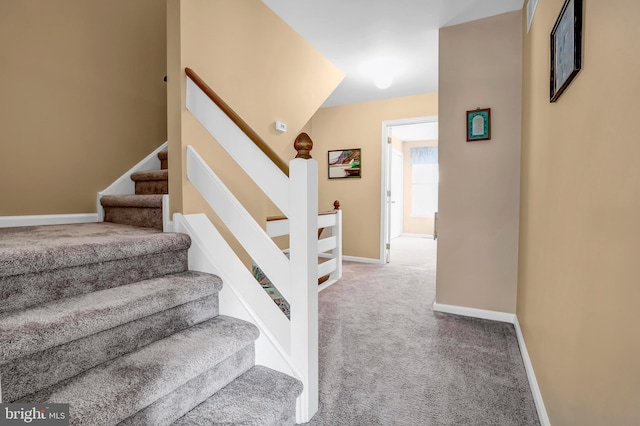 stairway with carpet and baseboards