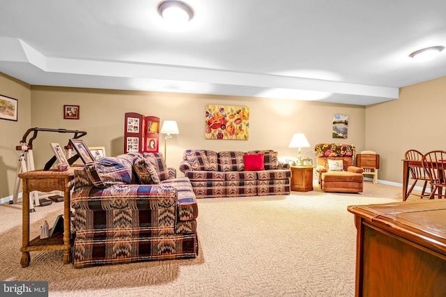 carpeted living room with baseboards