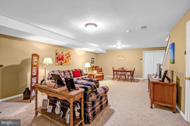 living area featuring light colored carpet and baseboards