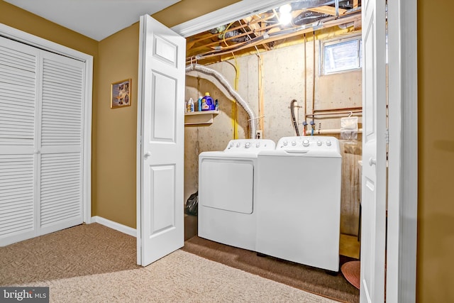 laundry room with washing machine and clothes dryer and carpet