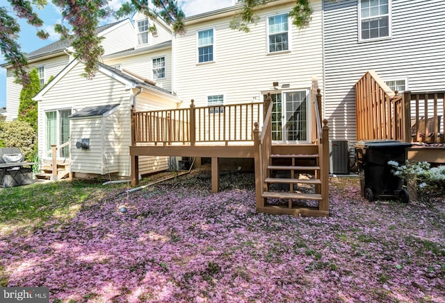 rear view of house featuring a deck and cooling unit
